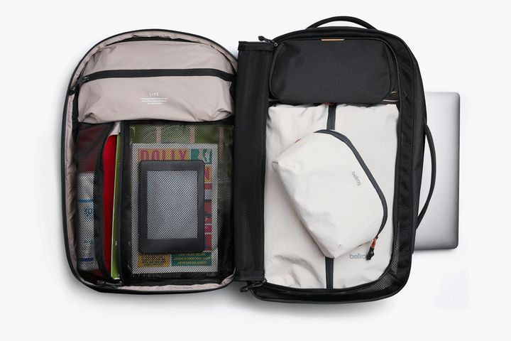 Bellroy Lite Travel Pack 30L in Black, opened to show its packing compartments